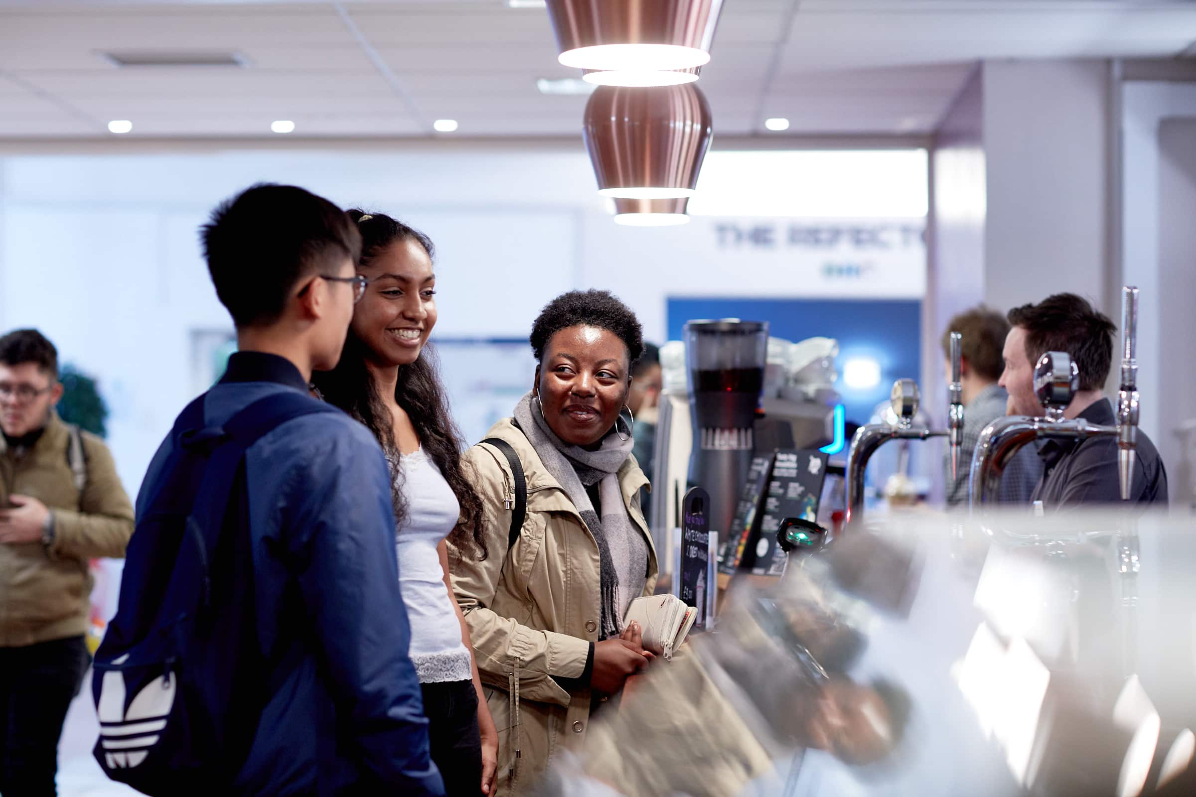 Students in cafe on campus ordering drinks 